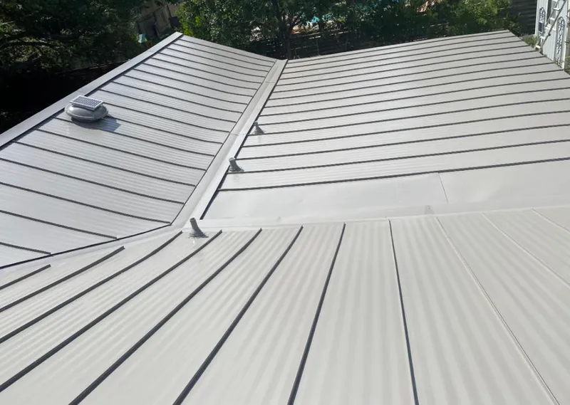 Solar attic fan installed on a metal roof for Roof Ventilation in Ada